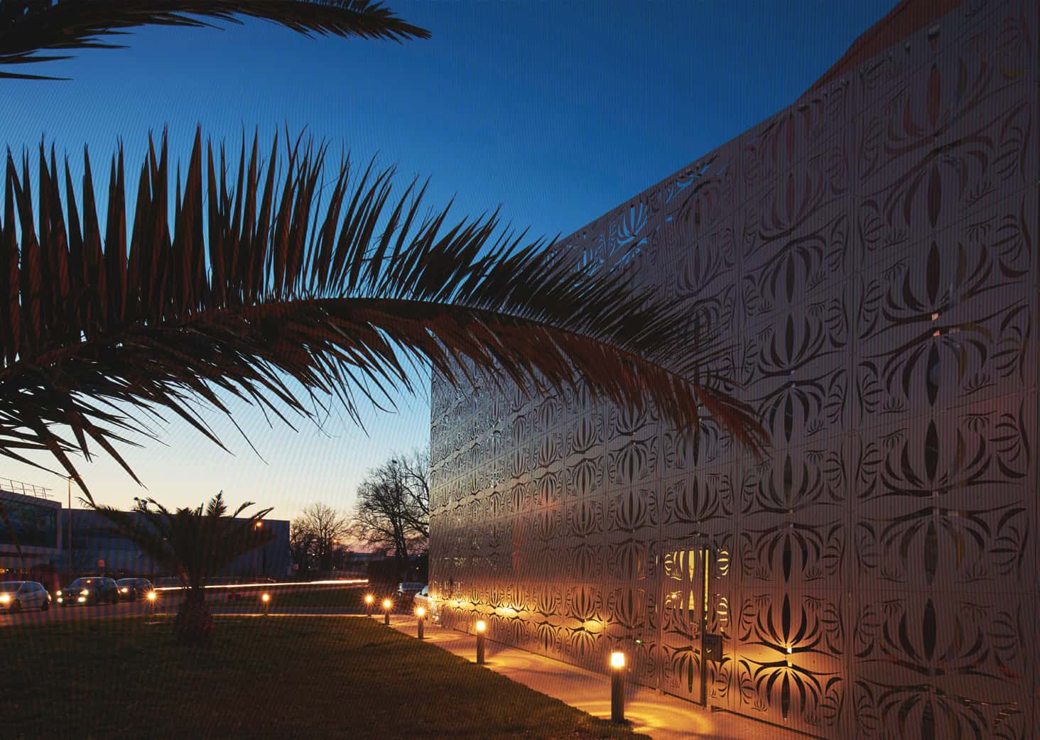 Urb1n, bâtiment moderne avec façade décorative illuminée, dans un environnement urbain paisible au c.